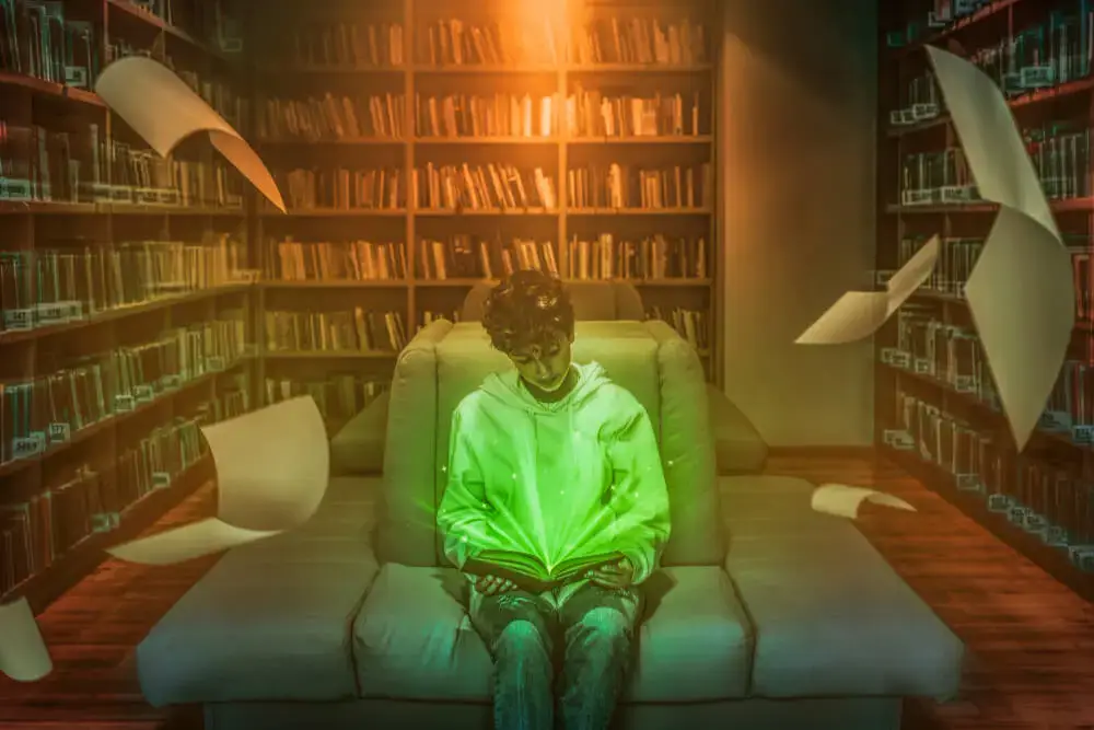 A person reading a book in a library of books